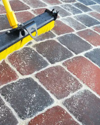 PCA Washing Paver Cleaning and Sealing filling in missing sand.